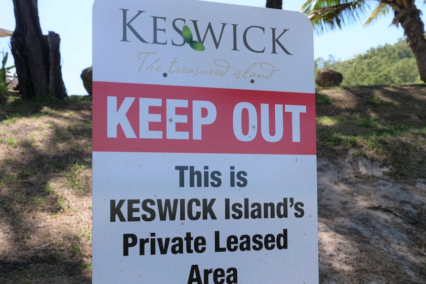 A "keep out" sign on a beach.