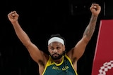 Australian basketball player Patty Mills raises his fists during the bronze-medal game against Slovenia at the Tokyo Olympics.