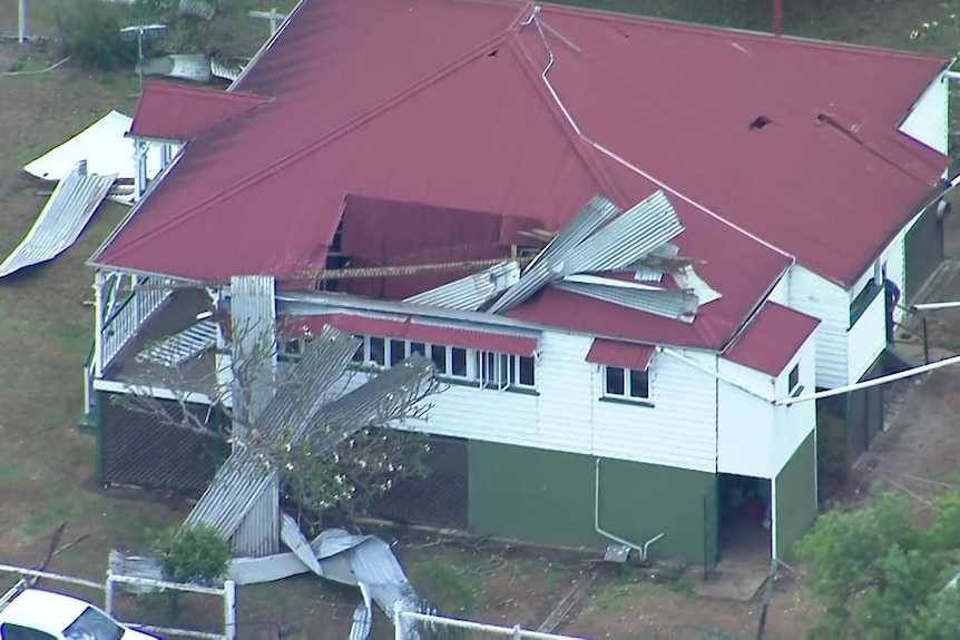 The roof of a Winya home is damaged and corrugated iron sticks out of it