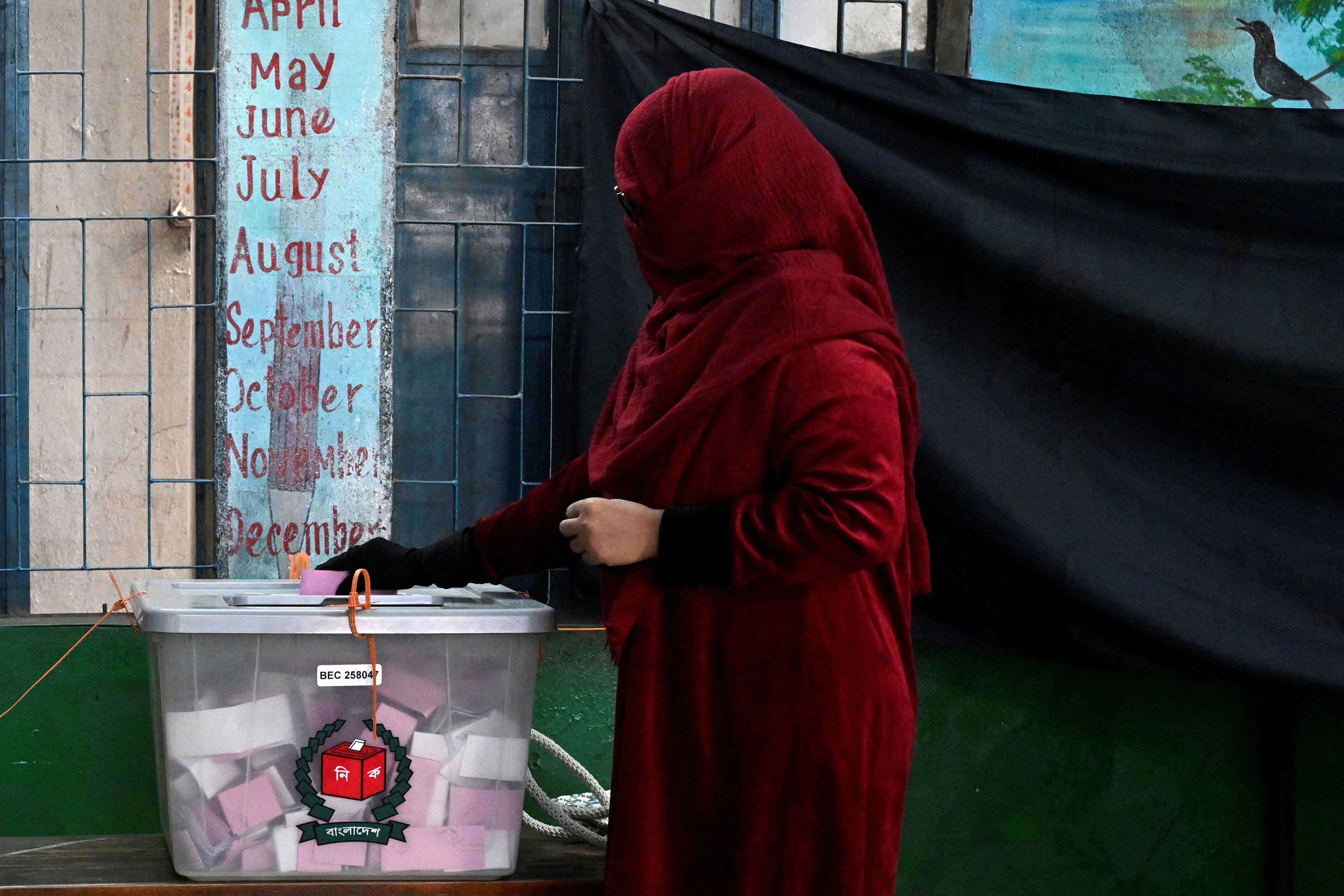Woman in hijab puts paper into sealed box