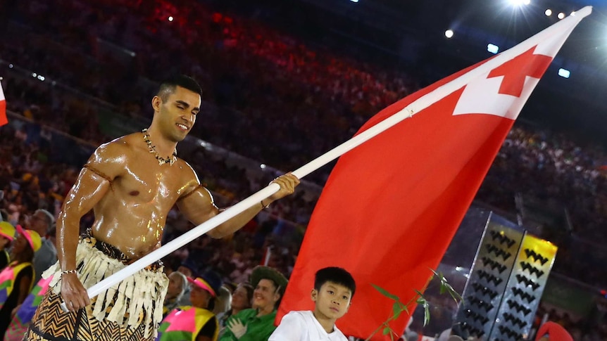 Flagbearer Pita Taufatufoa of Tonga leads his contingent during the Rio Olympics opening ceremony.