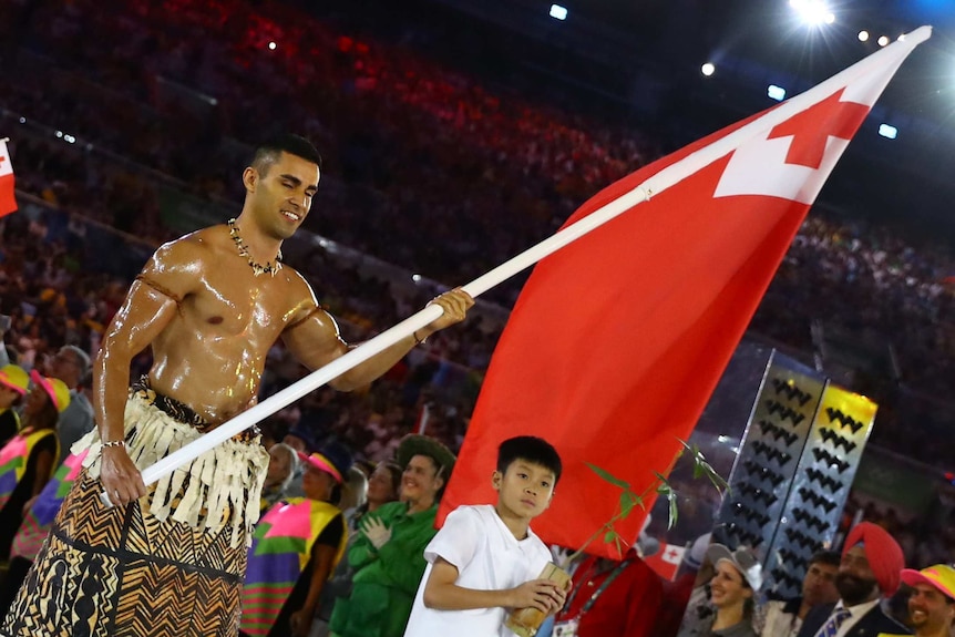 Flagbearer Pita Taufatufoa of Tonga leads his contingent during the Rio Olympics opening ceremony.