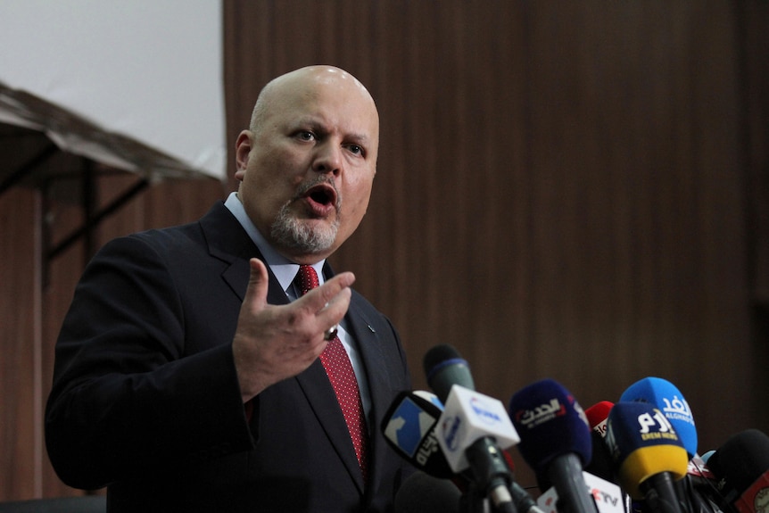 International Criminal Court chief prosecutor speaks at a lectern.