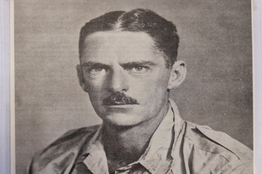 Black and white photo of a man with a moustache 
