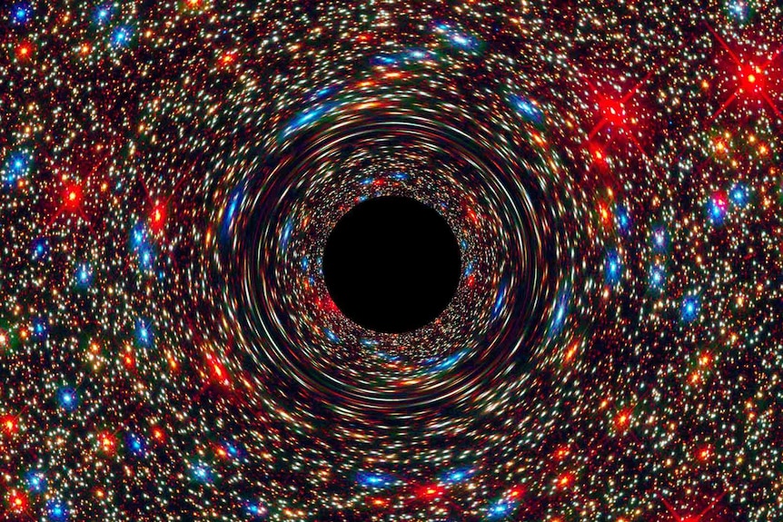 Colourful red, blue, orange, yellow and white dots that are surrounding a central black circle.