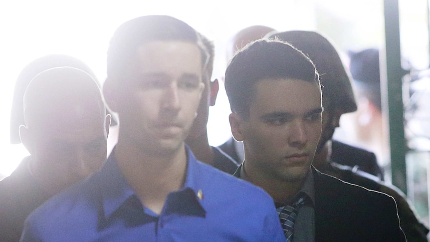 Joseph Scott Pemberton is escorted into a court room.