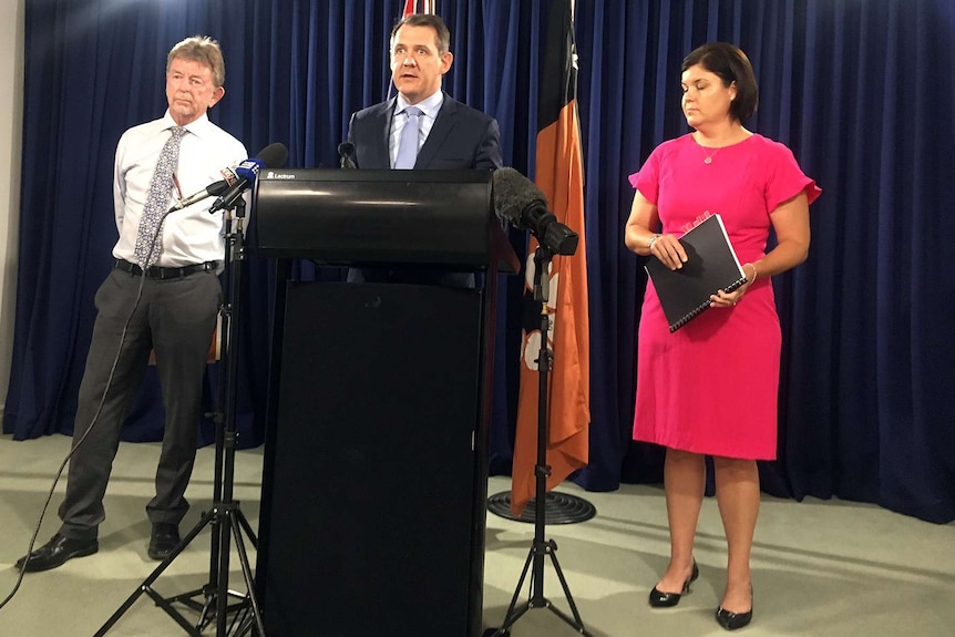 Former chief justice Trevor Riley and NT Attorney-General Natasha Fyles stand either side of NT Chief Minister Michael Gunner.