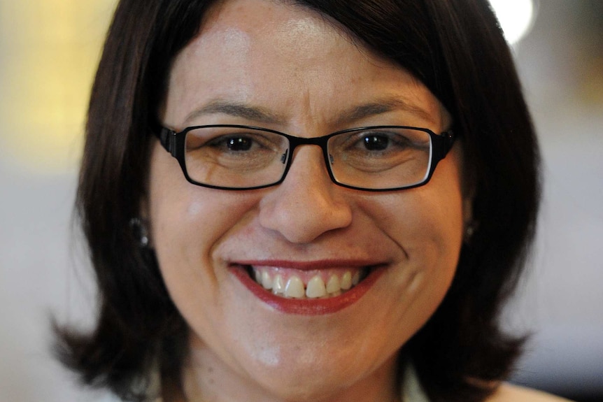 Jenny Mikakos smiles for a profile photo while holding a piece of paper.