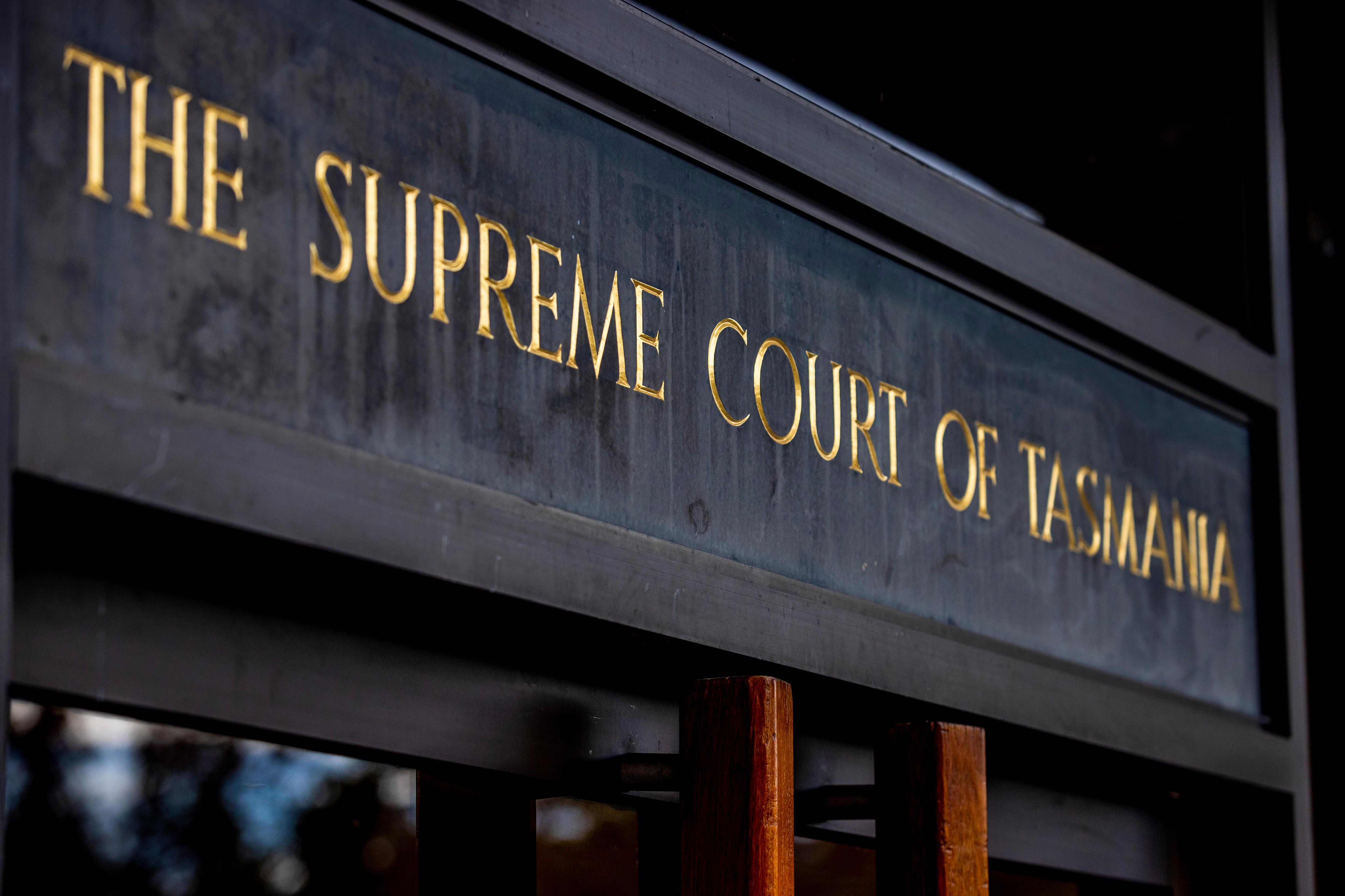 A sign that reads Supreme Court of Tasmania above two doors in Hobart.