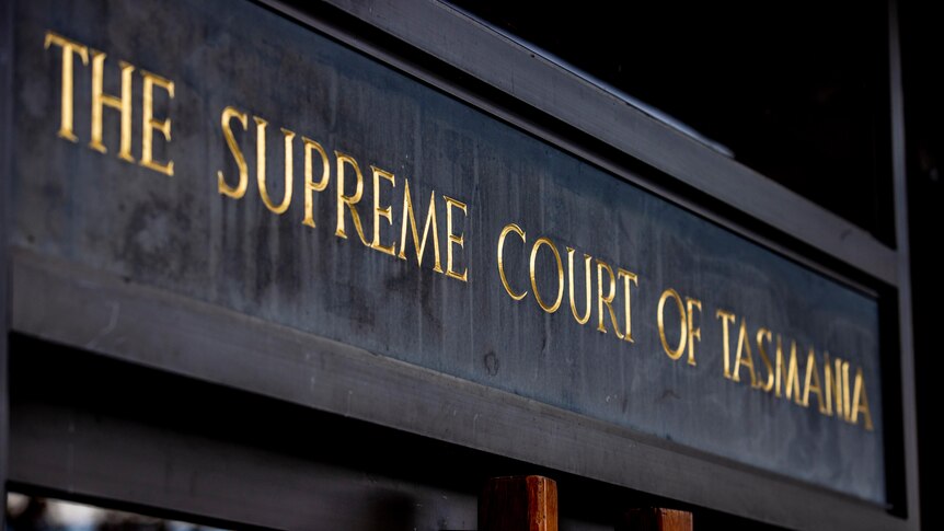 A sign that reads Supreme Court of Tasmania above two doors in Hobart.