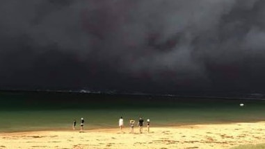 Bushfire smoke is seen over Long Beach at Batemans Bay on the New South Wales South Coast.