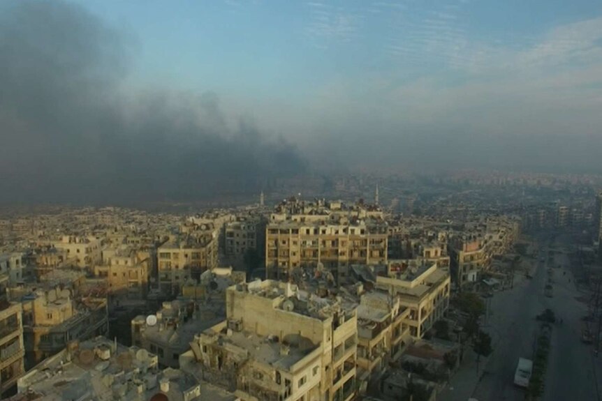 A still image of smoke rising over Aleppo