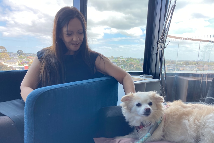 A woman and her dog in a high rise apartment