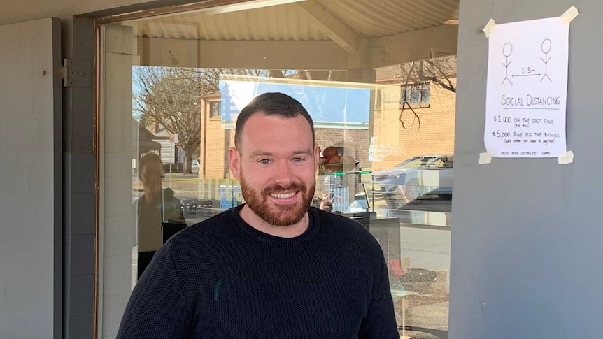 Business owner, Ricky Carver, outside his cafe in Orange, New South Wales