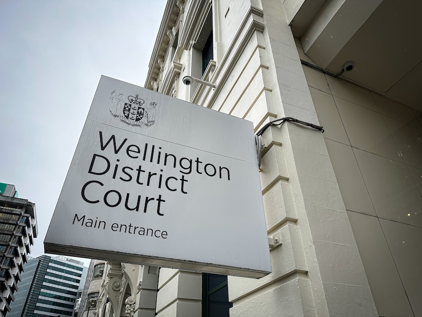 A sign outside a building reads Wellington District Court main entrance