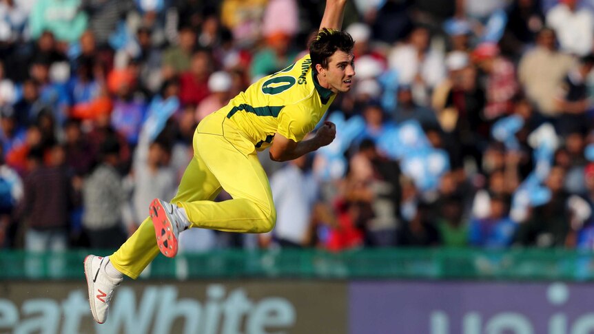 A bowler is at full-stretch after a delivery in a one-day international match.