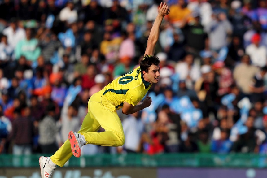 A bowler is at full-stretch after a delivery in a one-day international match.