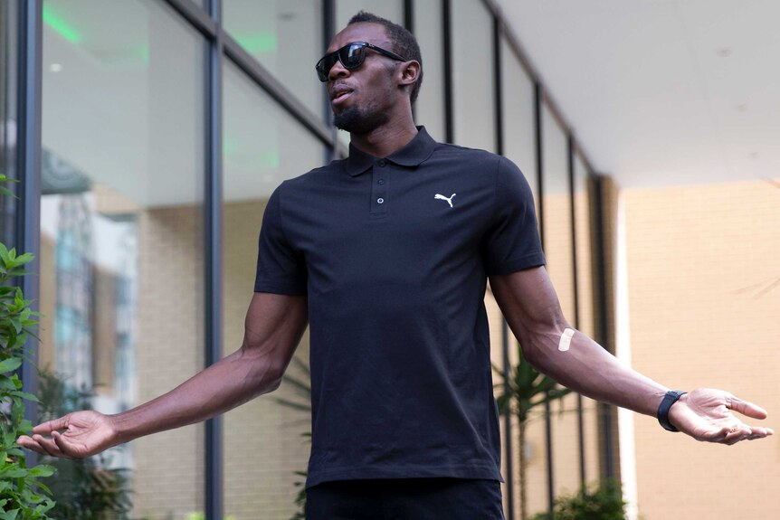 Usain Bolt poses for photographers