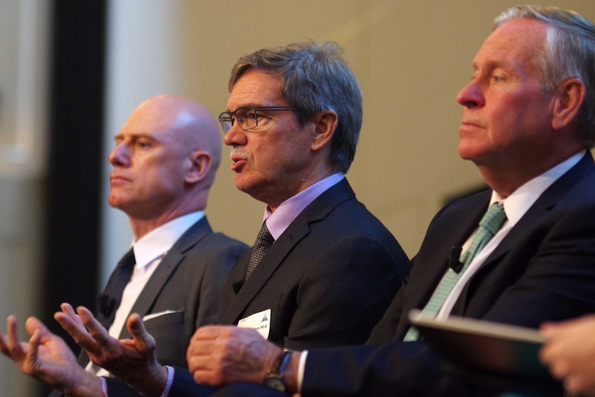 A side-on head and shoulders shot of Mike Nahan speaking with Colin Barnett on his left and Sean L'Estrange on his right.