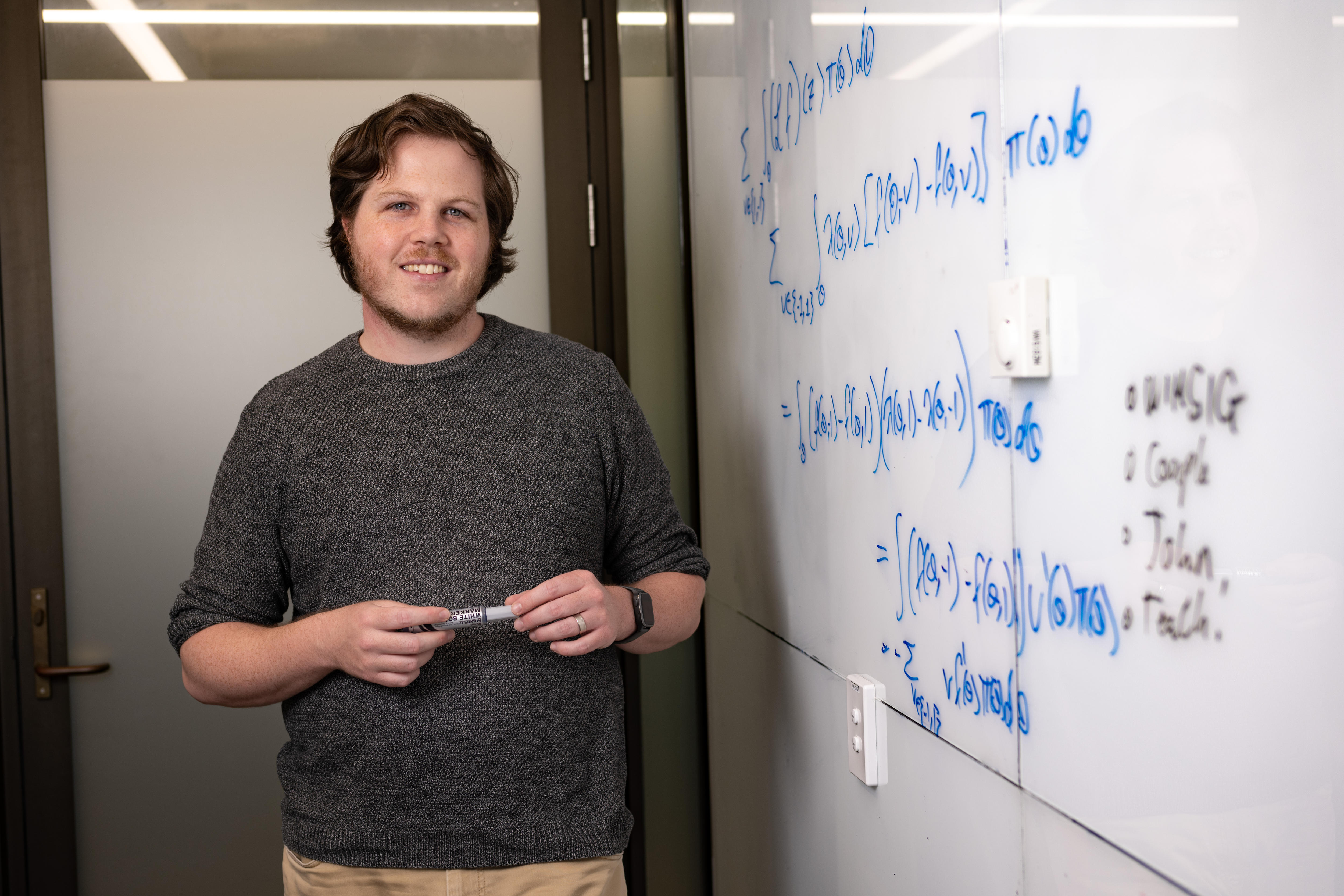 A man next to a whiteboard