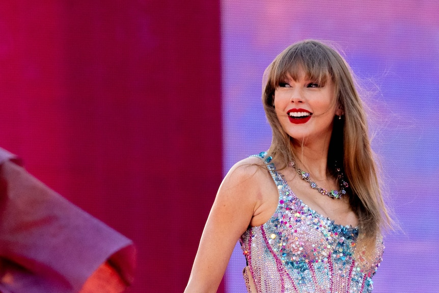 Taylor Swift close up on stage, smiling