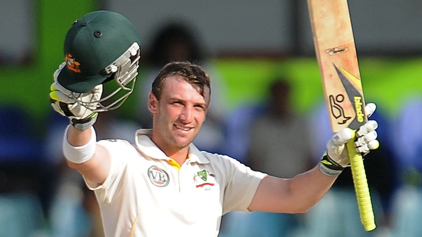 Phillip Hughes raising bat and helmet after century in Sri Lanka