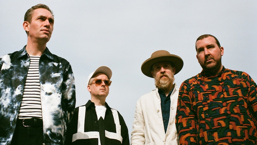 Four members of Hot Chip stare into the distance