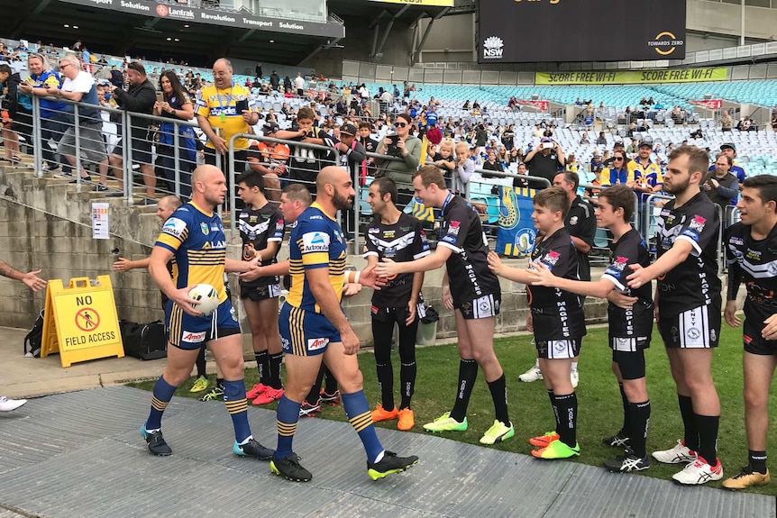 Players from the program greeting the NRL stars