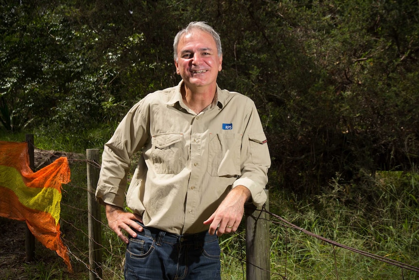 Darrell Rigby leans against a fence post.