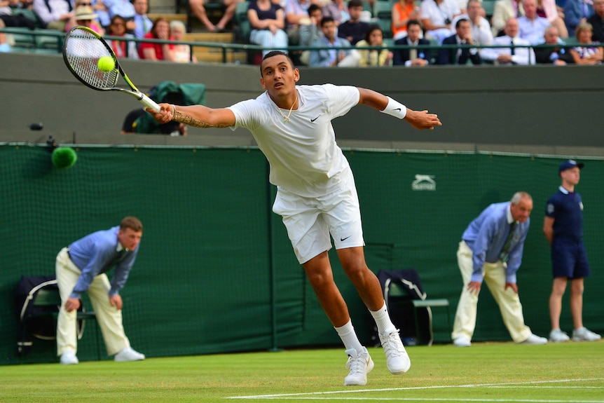 Nick Kyrgios stretches for a forehand at Wimbledon