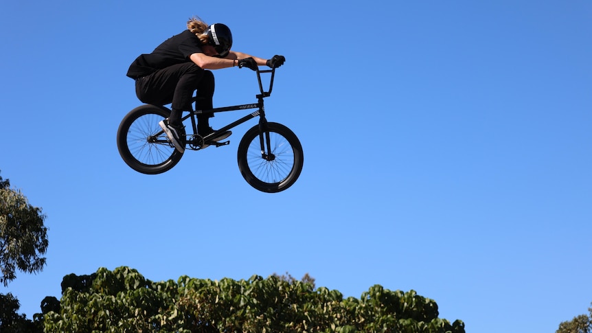 A BMX rider doing a jump from a ramp