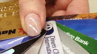 Person holding credit cards