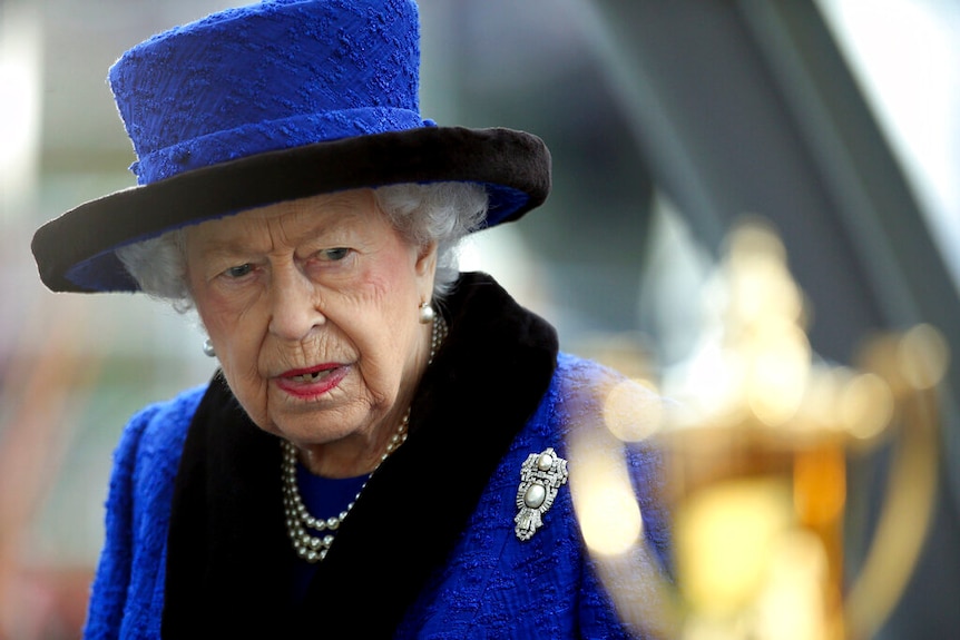 Queen Elizabeth in a blue hat.