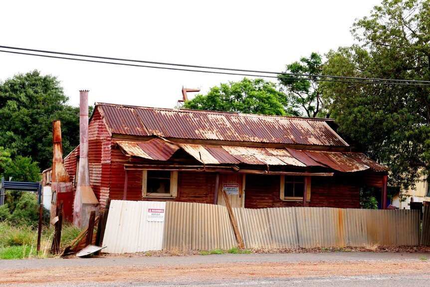 An old, rusty corrugated iron house.