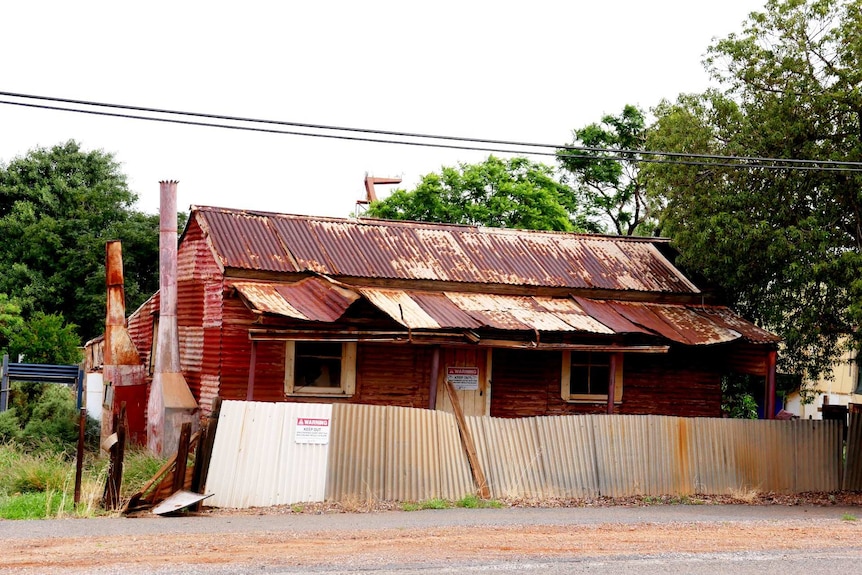 An old, rusty corrugated iron house.