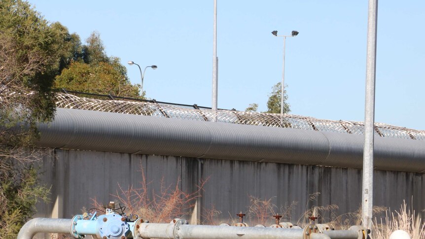 An exterior wall topped by barbed wire at the Banksia Hill Detention Centre.
