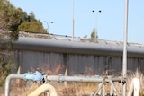 An exterior wall topped by barbed wire at the Banksia Hill Detention Centre.