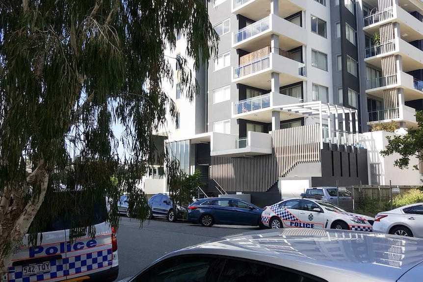 Police outside the apartment building of childcare worker Samuel Thompson at Albion in Brisbane's north