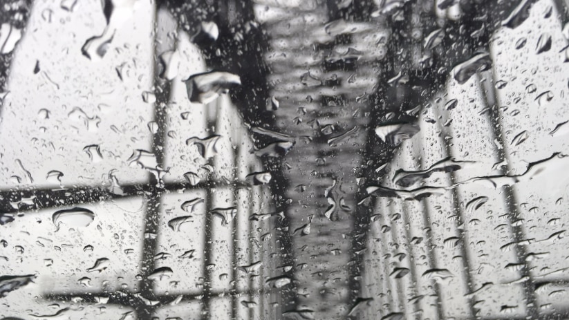 Sydney Harbour Bridge, seen through the windscreen of a car in a deluge of rain.