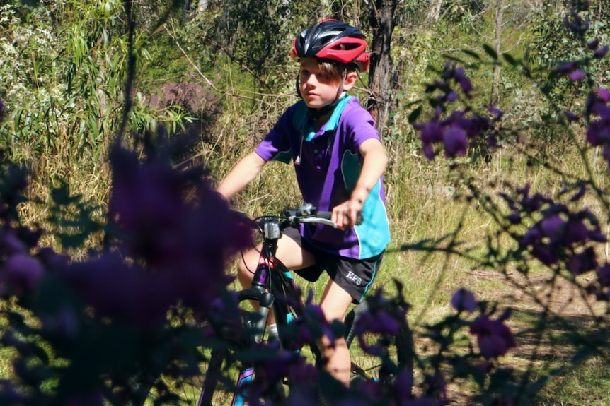 a boy riding a bike