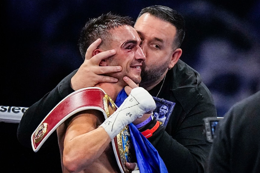 Jason Moloney is kissed on the head by his trainer after winning a fight