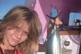 Jessica Watson shows off a catch of fish during her attempt to circumnavigate the globe.