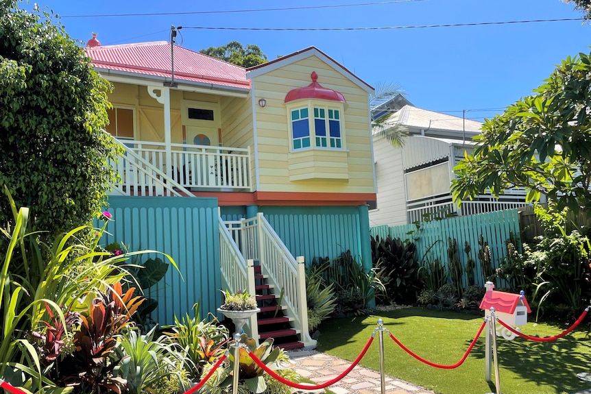 A small yellow and red cottage made to look like the Bluey house