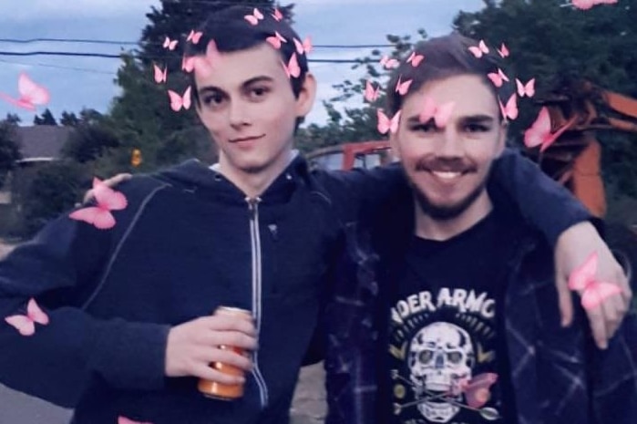 two teenagers posing for a photo with animated butterflies around them