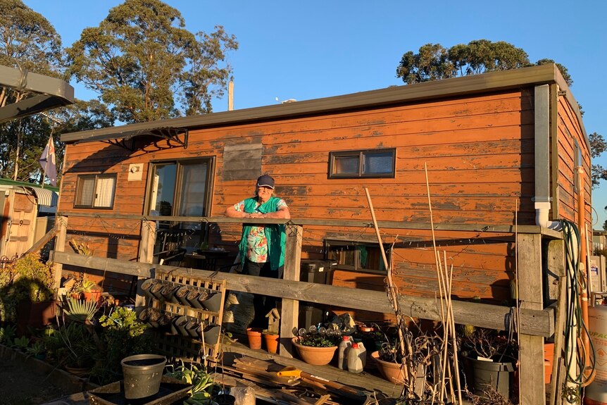 woman standing on deck of tiny home