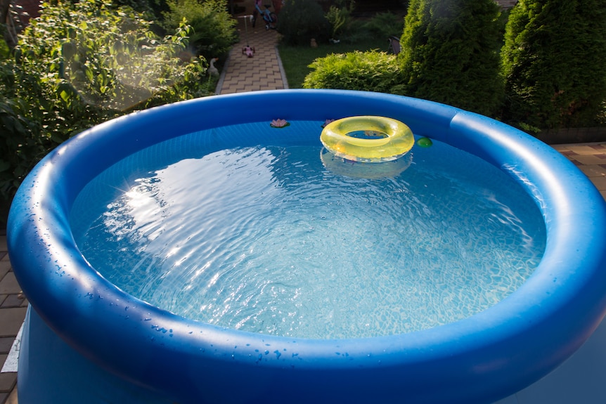 An inflatable pool with a blow up ring floating in it