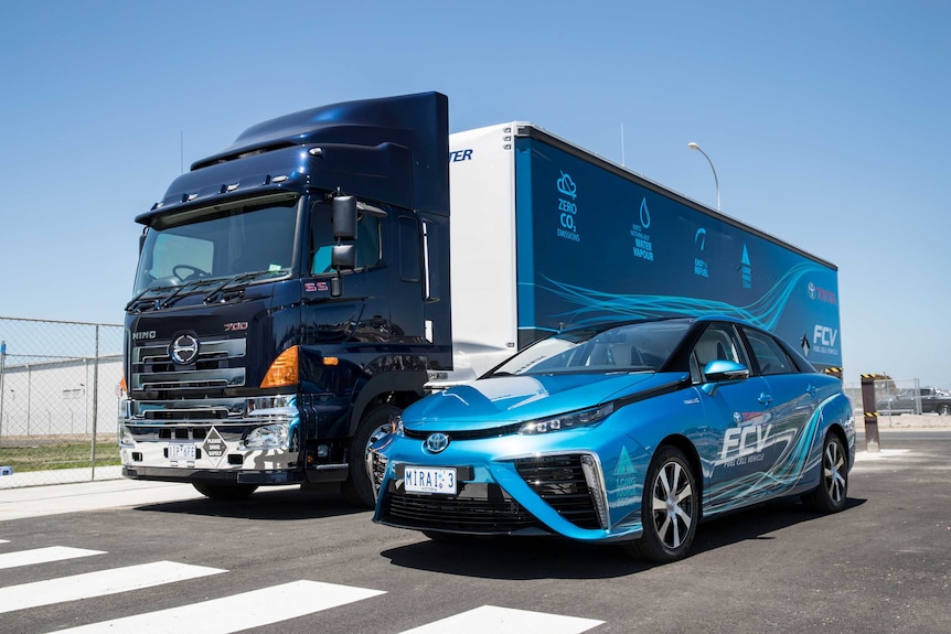 A Toyota Mirai hydrogen car sits alongside a large truck housing a portable refueller.