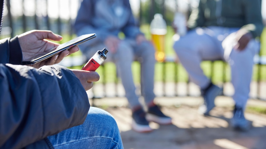 person holding a vaping device