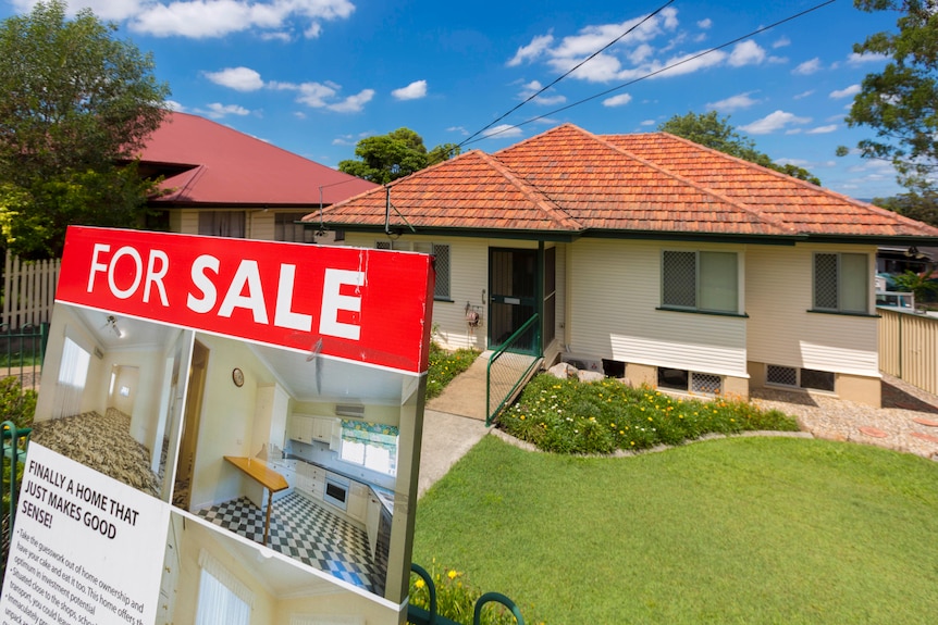 For sale sign in front of property with orange roof