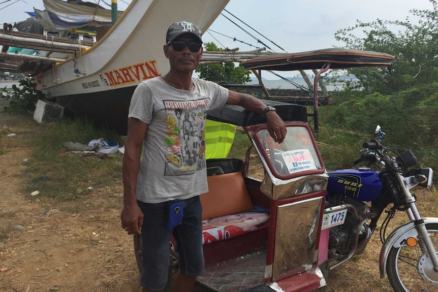 Filipino fisherman Junick Josol with a tricycle taxi.